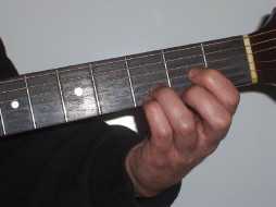 Picture of hand holding Dsus4 in open on guitar