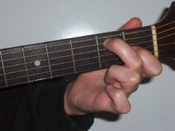 Picture of hand holding open E7 chord shape
